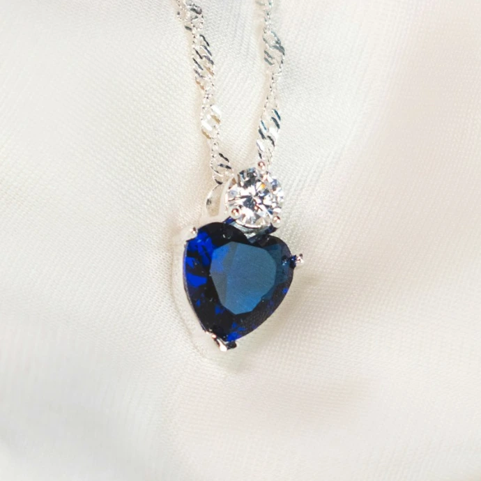 silver necklace with blue gemstone pendant