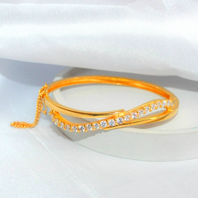 a gold ring on a white surface